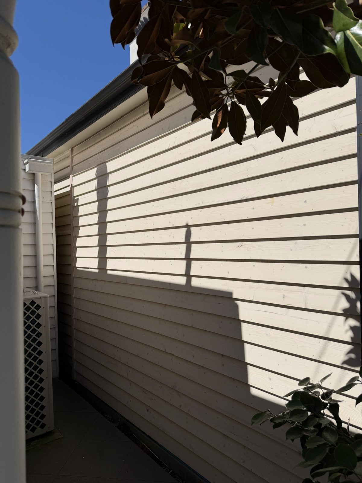 Exterior weatherboard cladding along a side passage