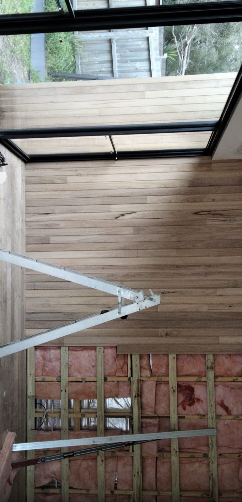 Timber lined ceiling cladding installed around a skylight