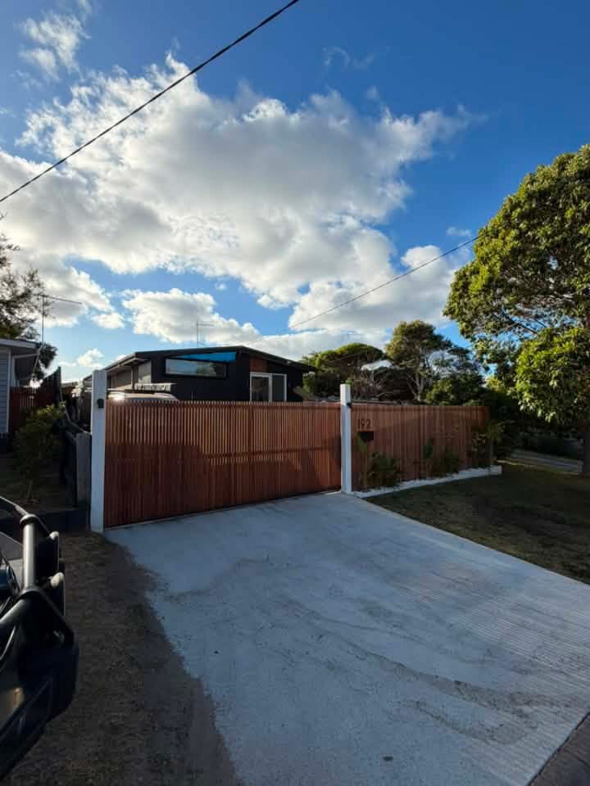 Timber slat driveway gate and fence