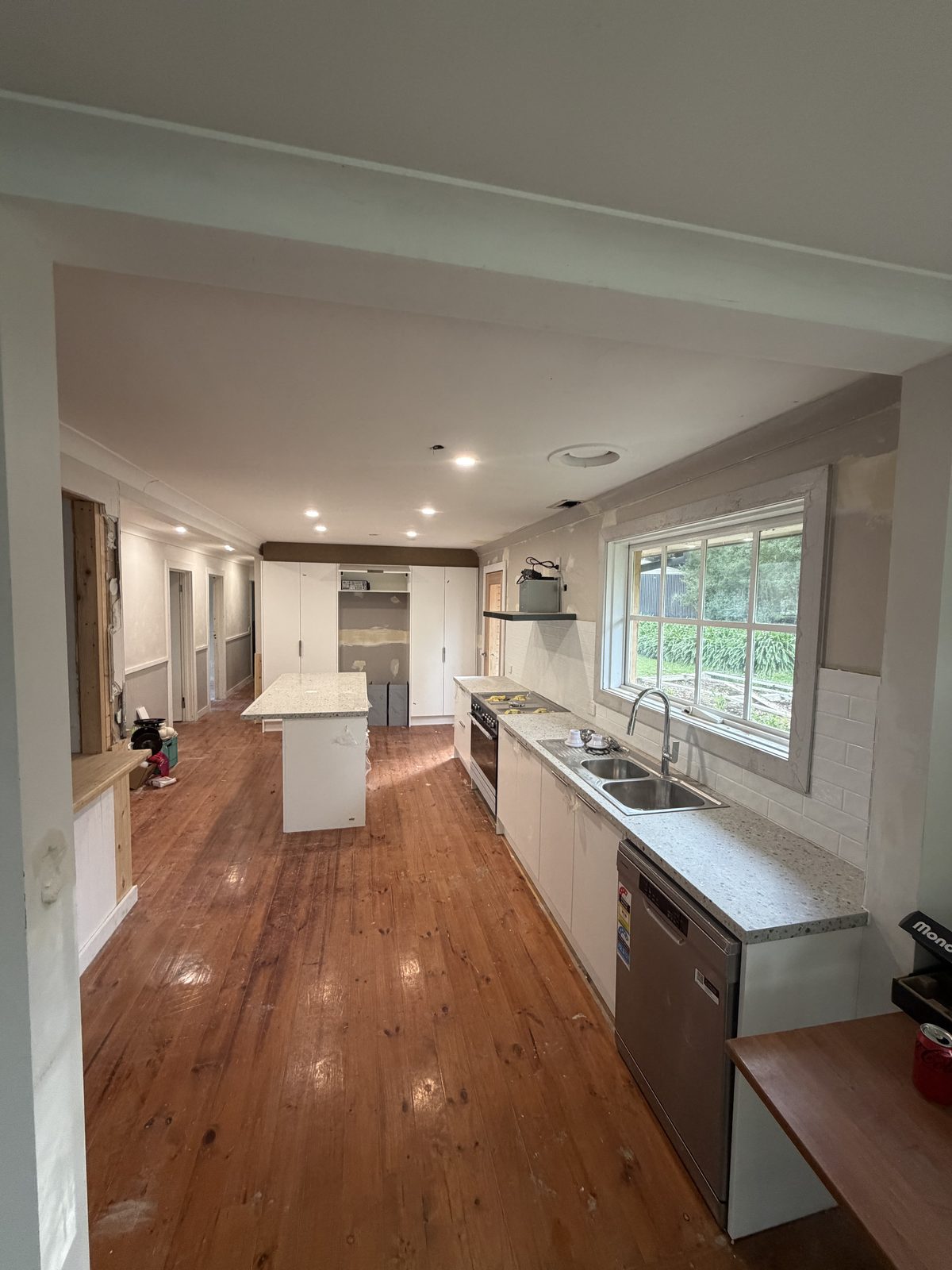Open-plan kitchen renovation with timber flooring